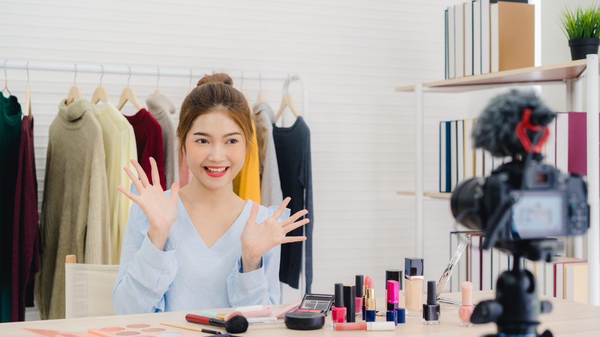 Beauty blogger present beauty cosmetics sitting in front camera Beauty blogger present beauty cosmetics sitting in front camera for recording video. Beautiful asian woman use cosmetics while review make up tutorial broadcast live video to social network by internet.
